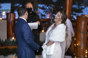 A laughing couple during an elopement ceremony at A Bear & Bison Inn in Canmore, Alberta.