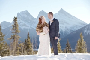 A couple with the Rocky Mountains behind them during an elopement.