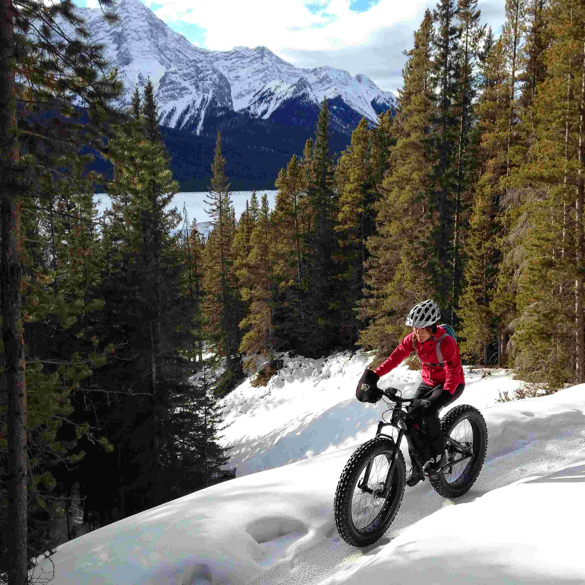 woman on fatbike in mountains, snows