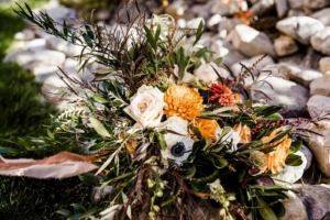 Fall wedding bouquet with orange, cream, and white flowers for a Golden Larch Micro Wedding in Canmore.